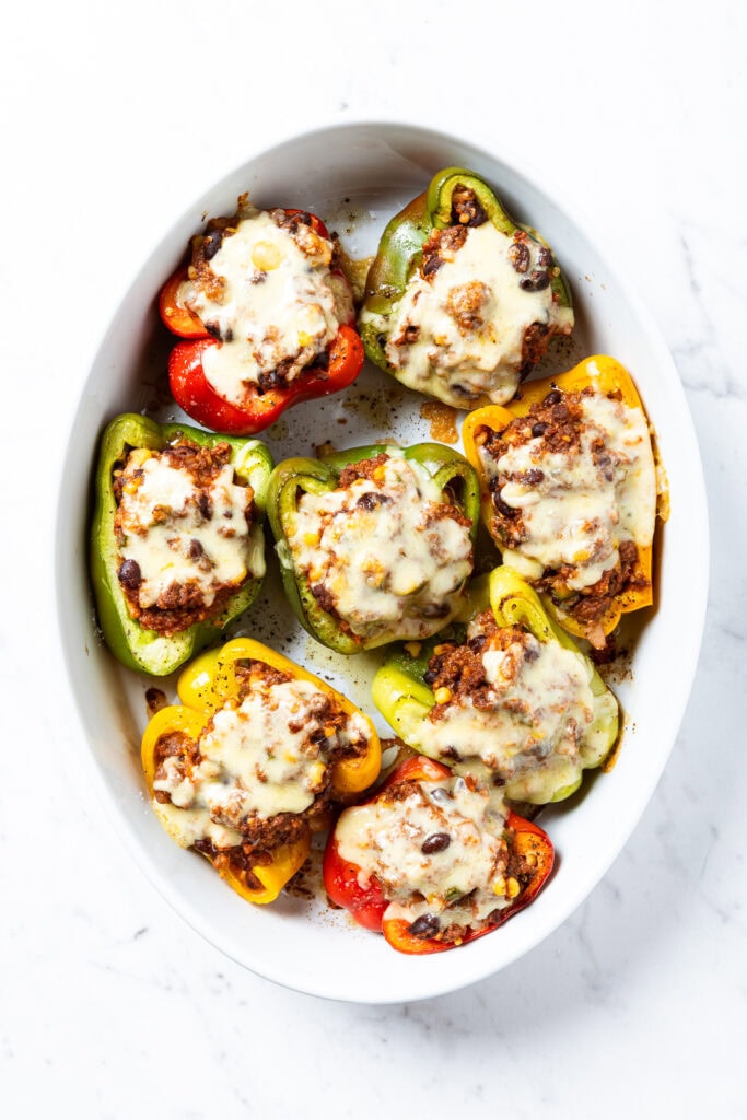 Baked stuffed bell peppers in a baking dish.