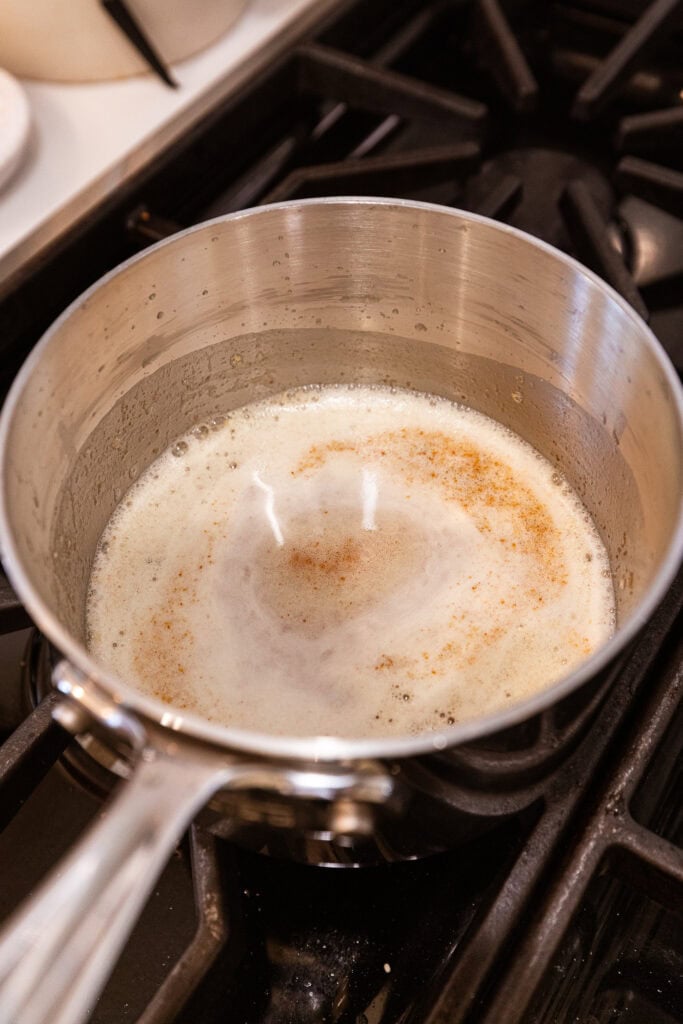 Pan filled with brown butter showing flecks of browned butter.