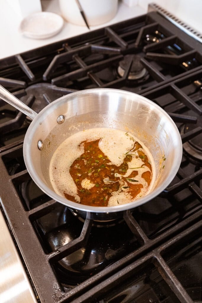Basting liquid sits on a stove.