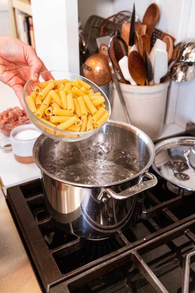 Pasta gets added to a pot of boiling water.