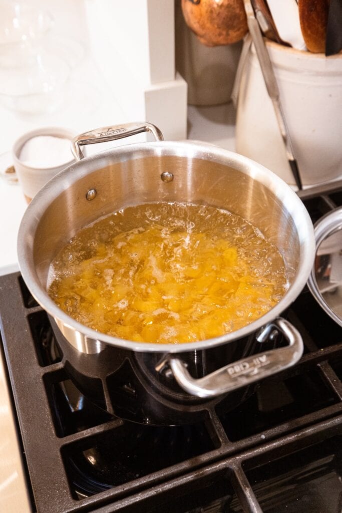 Pasta cooks in a pot of water.