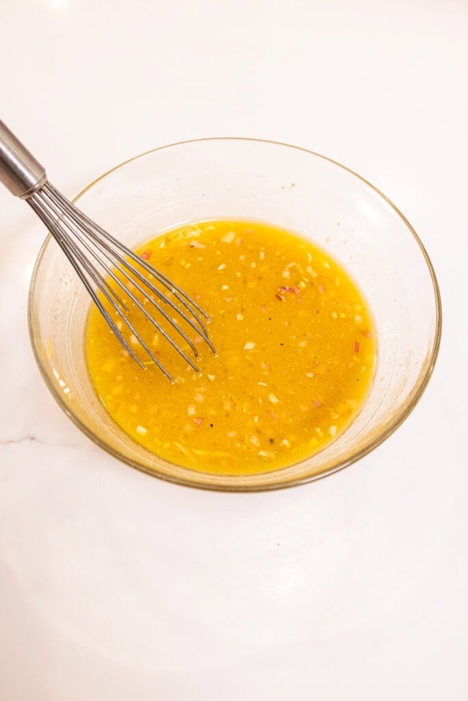 A vinaigrette in a bowl after getting emulsified.