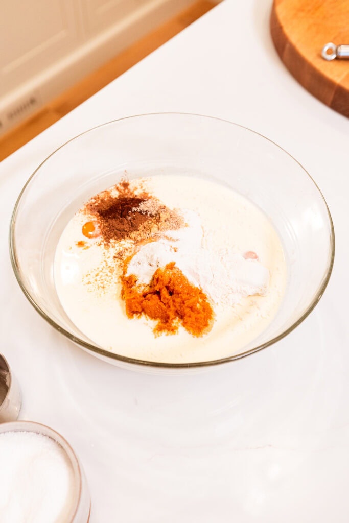 Ingredients to create pumpkin pie filling in a bowl prior to mixing.