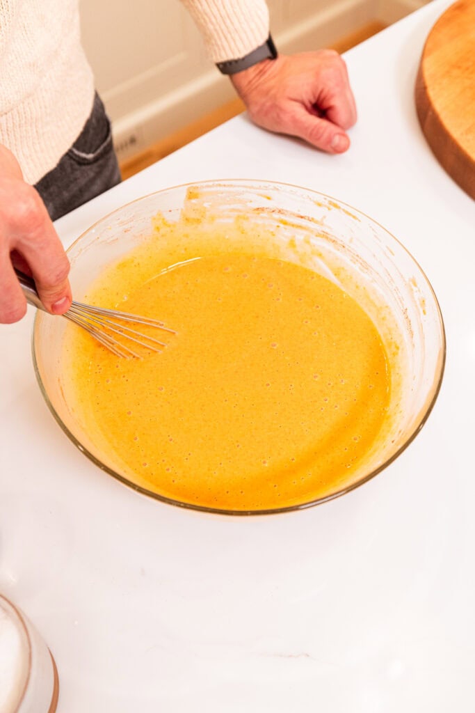 Mixed pumpkin pie filling sits in a bowl.