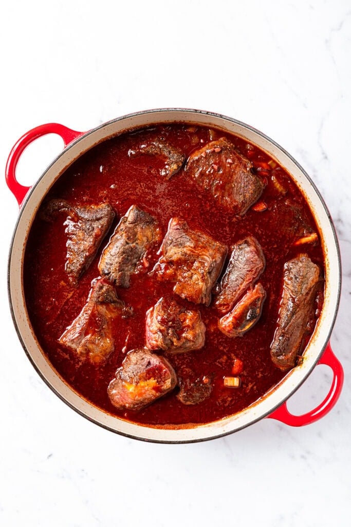 Short ribs in a Dutch oven prior to baking.