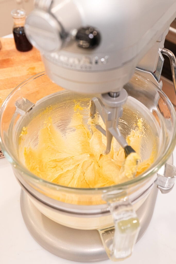 Mixing together dry and wet ingredients in a stand mixer to create cookie dough.