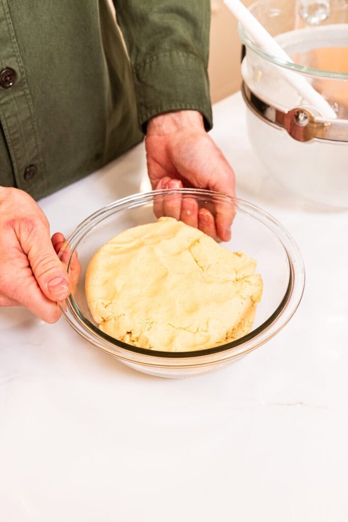 Snickerdoodle cookie dough sits in a glass bowl.