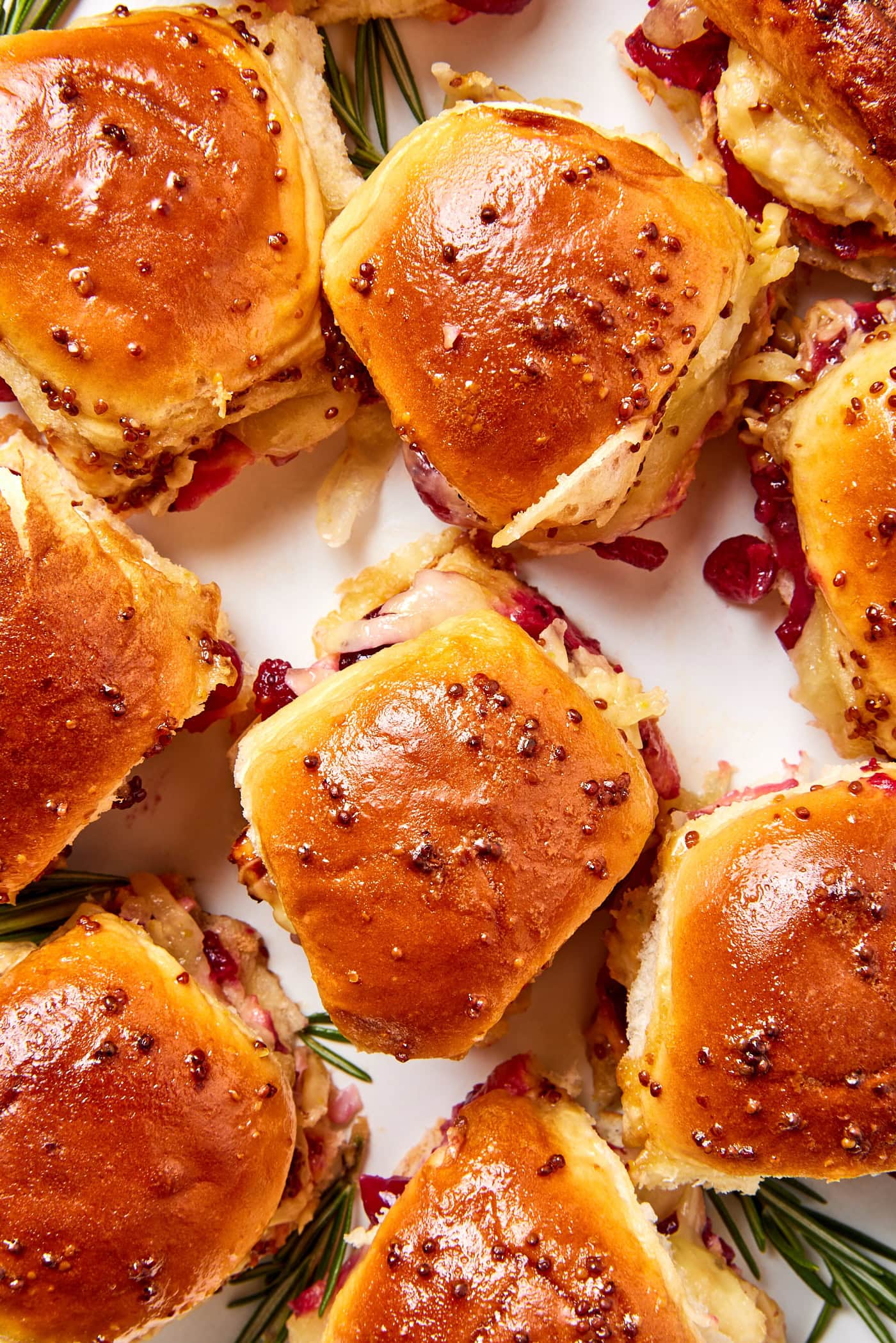 Small holiday sandwiches scattered randomly on a platter.