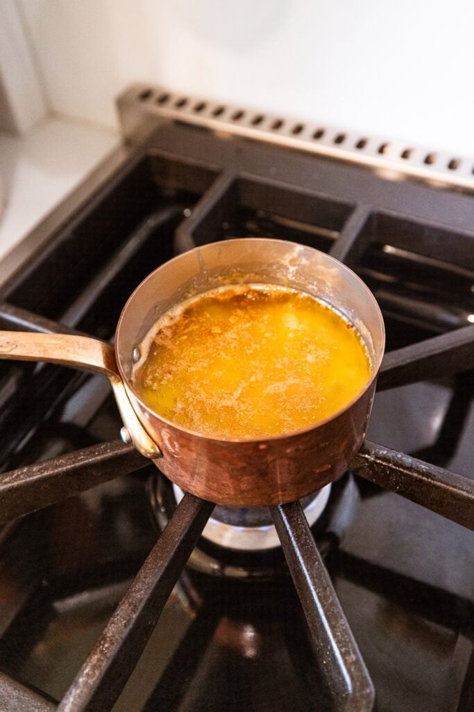 Butter, honey, mustard and Worcestershire sauce melt and combine on a stove.