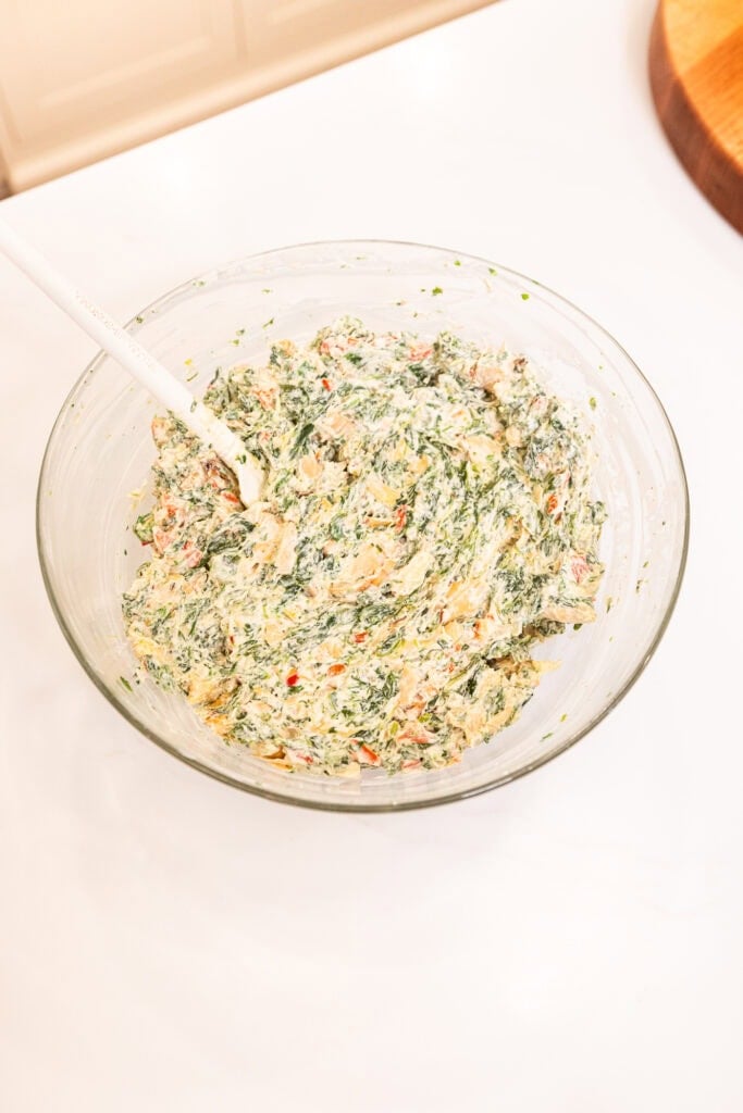 Assembled spinach artichoke dip in a bowl.