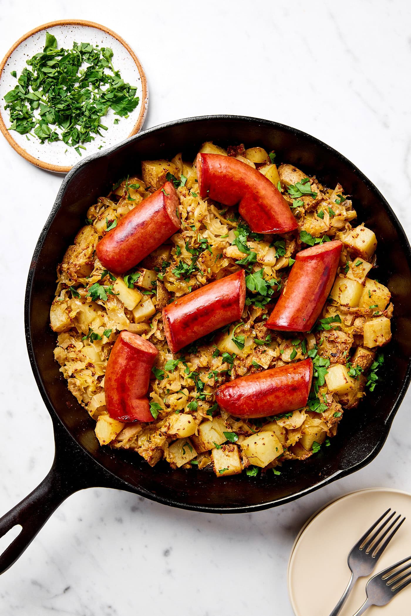 Skillet kielbasa and sauerkraut in an iron skillet.