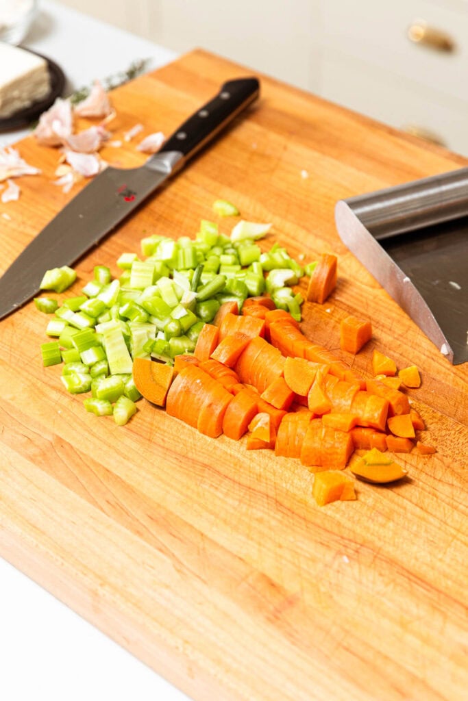 Chopped celery and carrot on a cutting board.