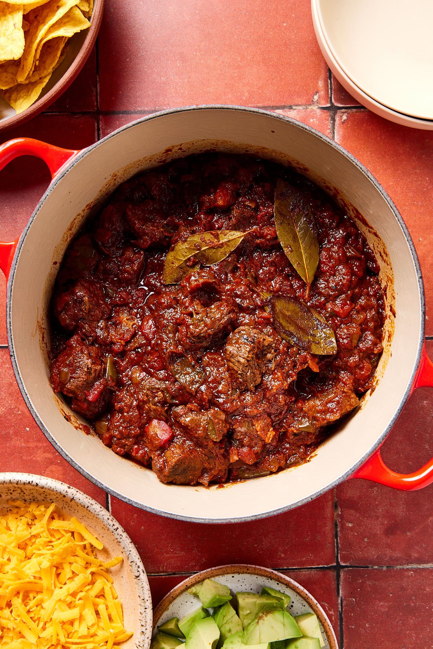 Chili con carne in a pot on a tiled countertop.