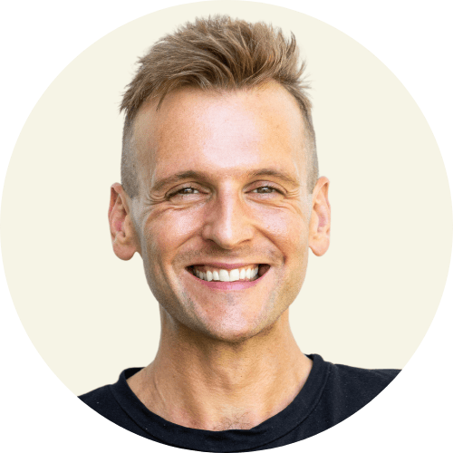 Kaleb Wyse wearing black shirt with a tan background.