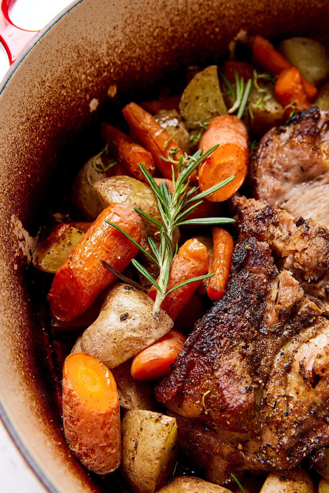 Rosemary sitting over roasted vegetables.