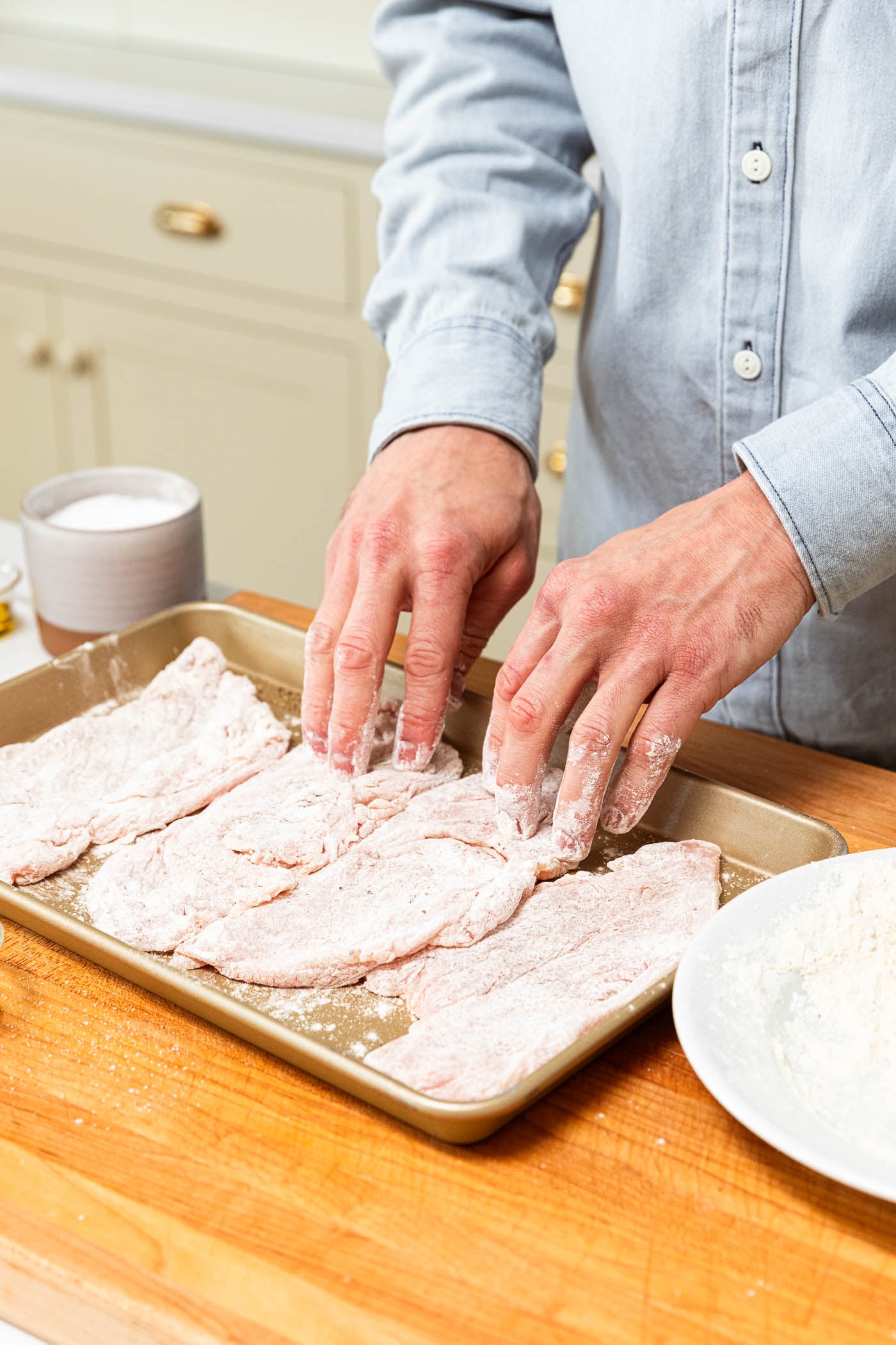 Chicken cutlets after being dredged in flour.