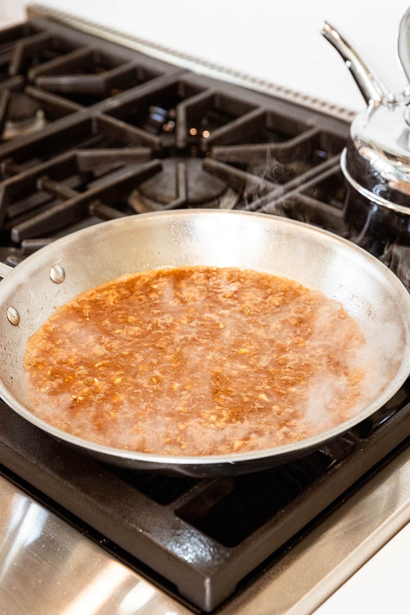 Orzo sauce simmering over the stove.