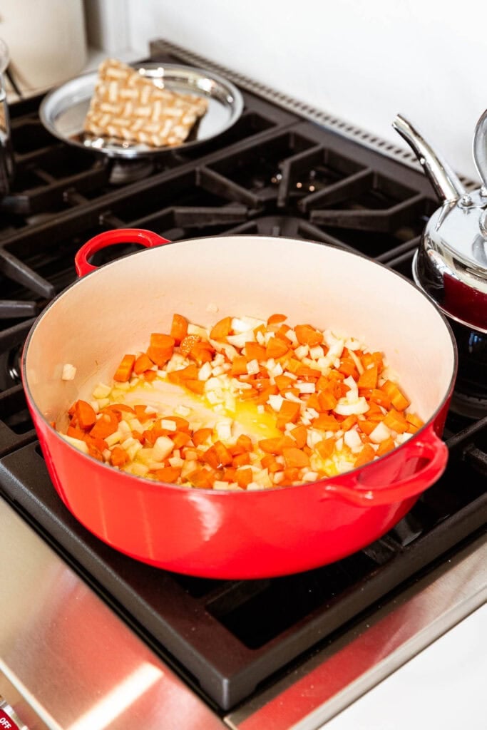 Sautéing vegetables in a pot.