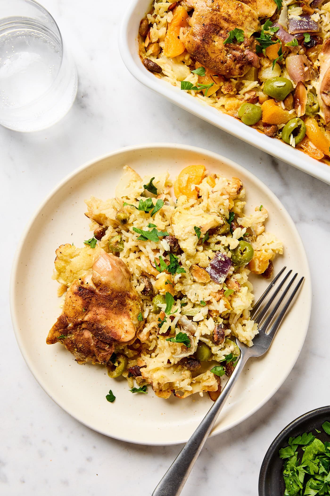 A plate with chicken rice pilaf and a fork.