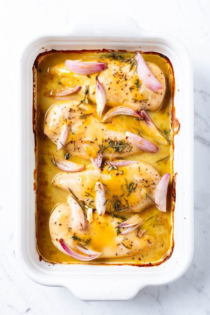 Honey mustard chicken breast in a baking dish after roasting in the oven.