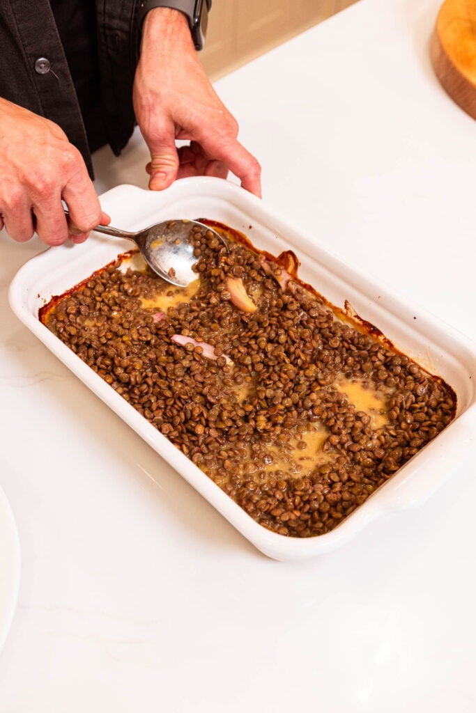 Mixing lentils in with honey mustard sauce.