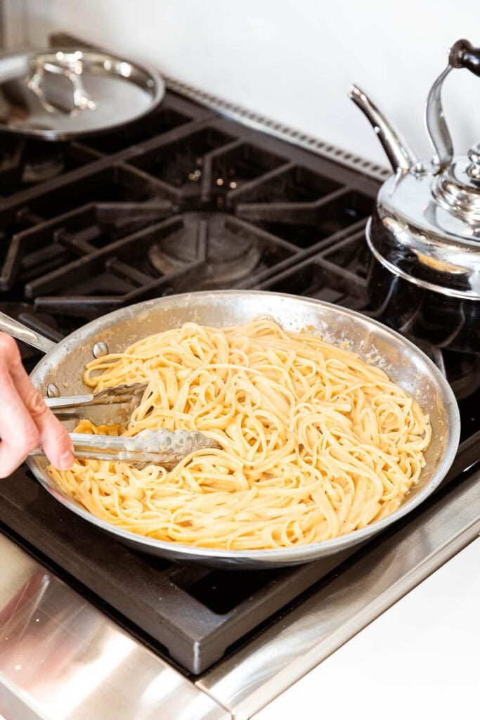 Stirring noodles with lemon butter sauce.