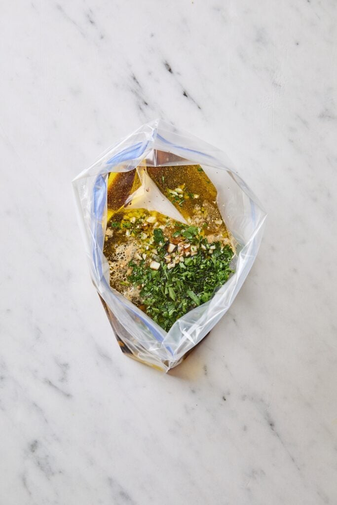 Plastic bag filled with ingredients for a steak marinade.