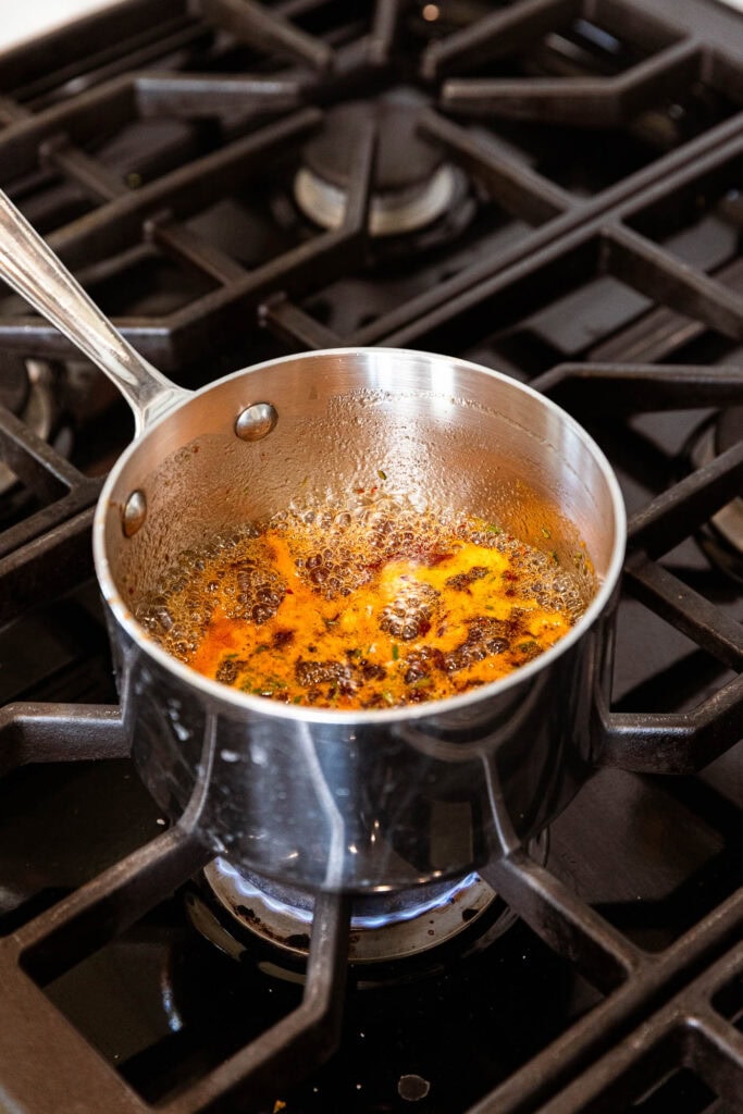 Orange chipotle glaze simmers over the stove.