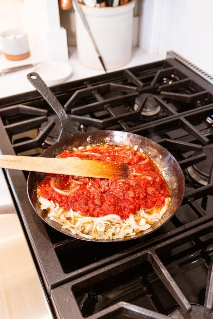 Tomato sauce for ratatouille heating on a stove.