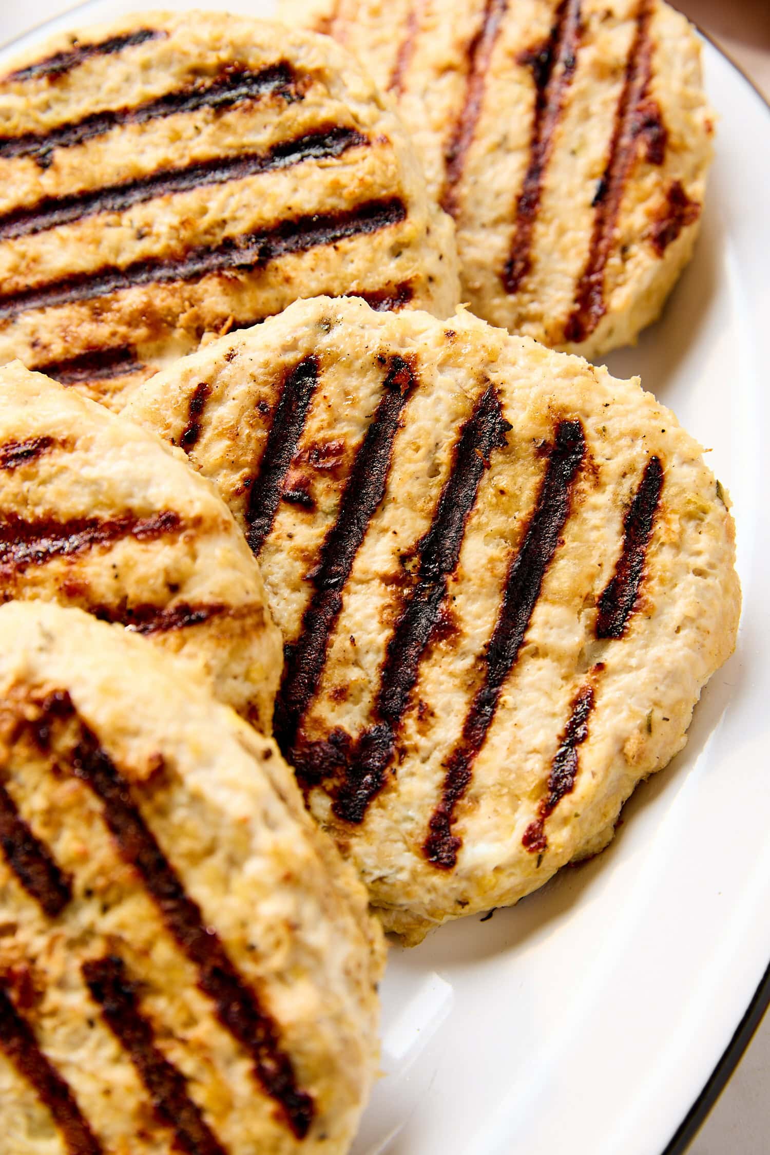 A plate of grilled chicken patties on a table