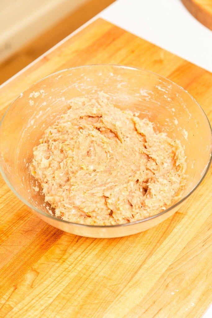 Mixed chicken burger meat in a bowl prior to being made into patties.