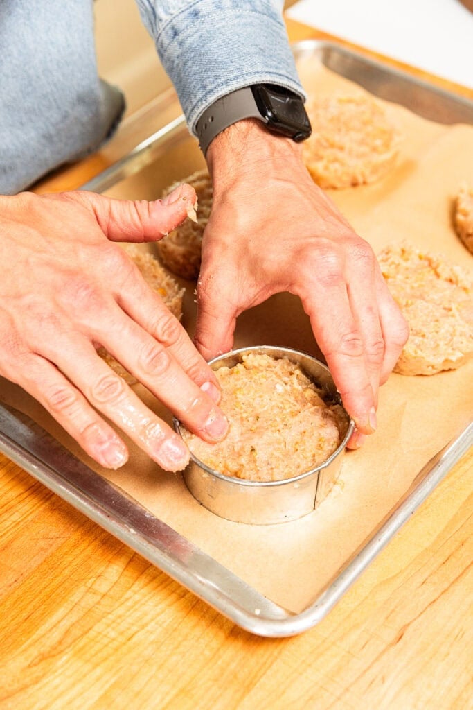 Forming burger patties with a biscuit cutter.