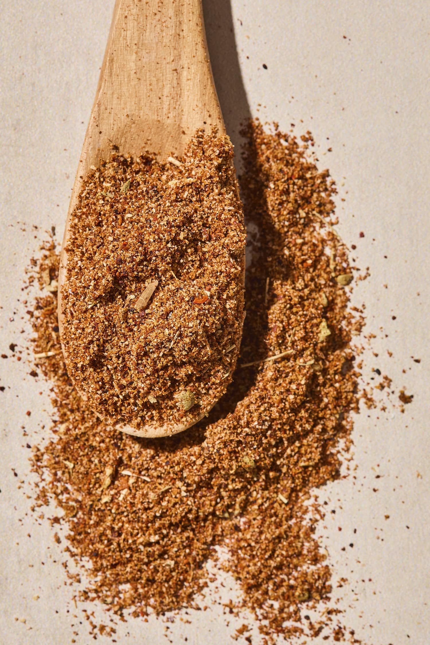 Wooden spoon with homemade taco seasoning blend.