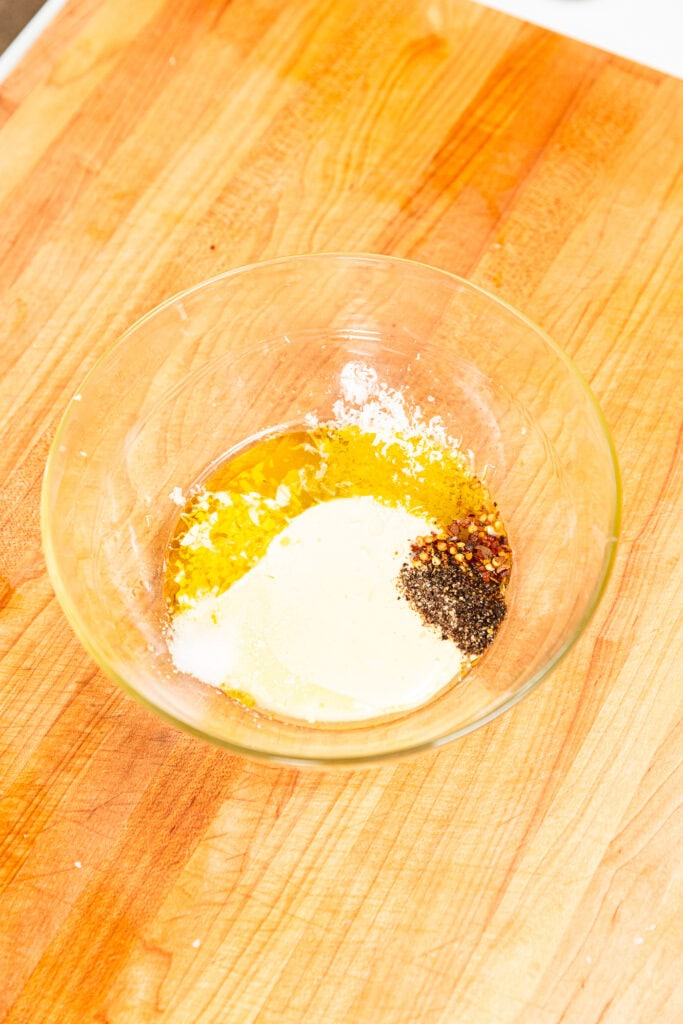 Ingredients to make pasta salad dressing in a small bowl.