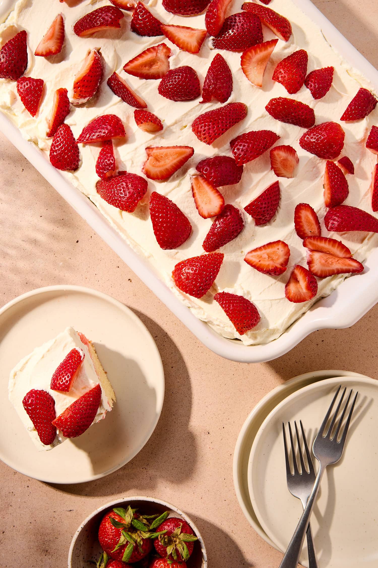 A cake topped with quartered strawberries.
