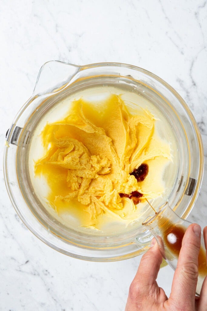 Adding vanilla to cake batter.