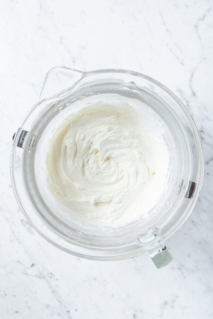 Whipped cream in a mixing bowl.