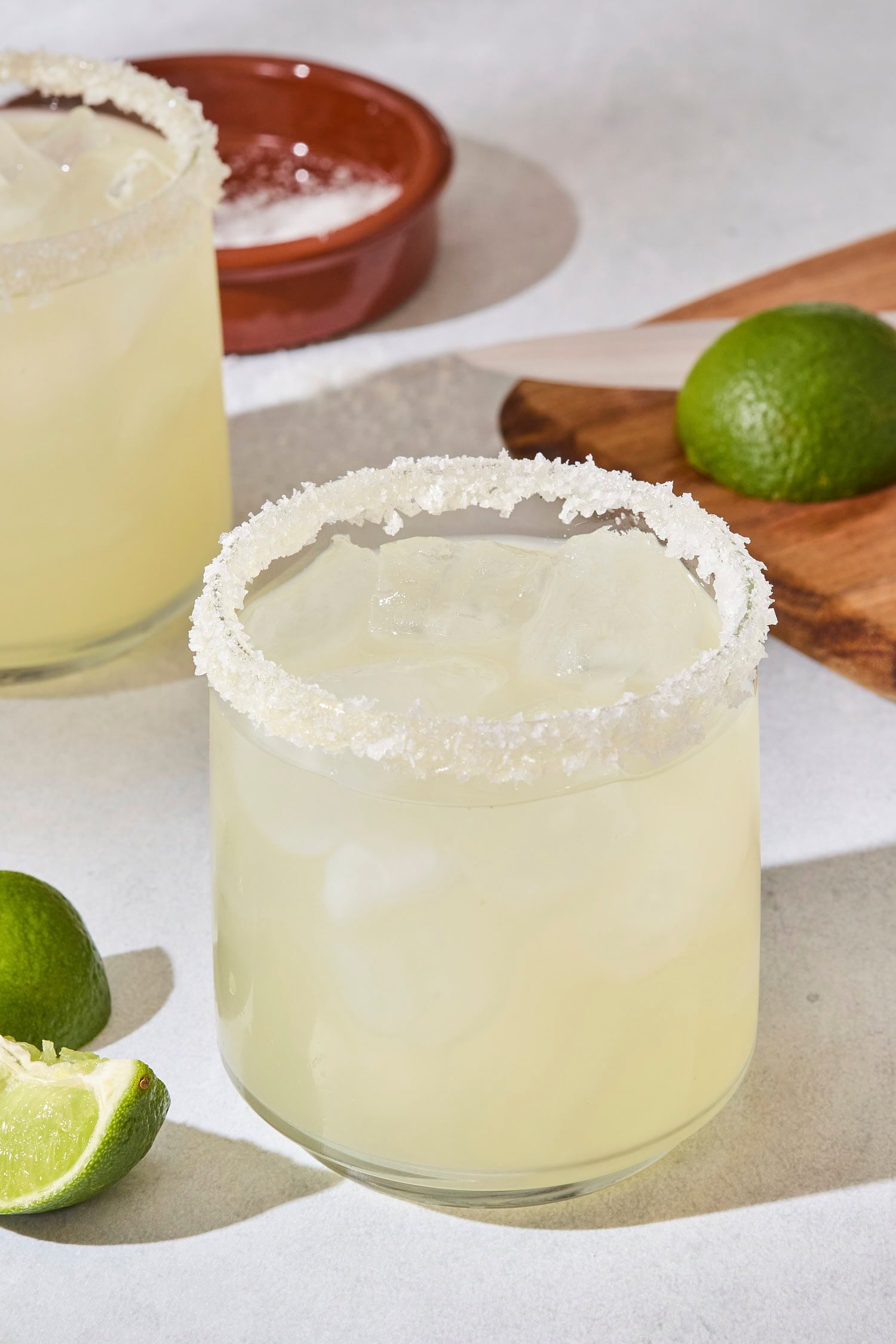 Glass filled with a lime margarita with salt rim on glass.