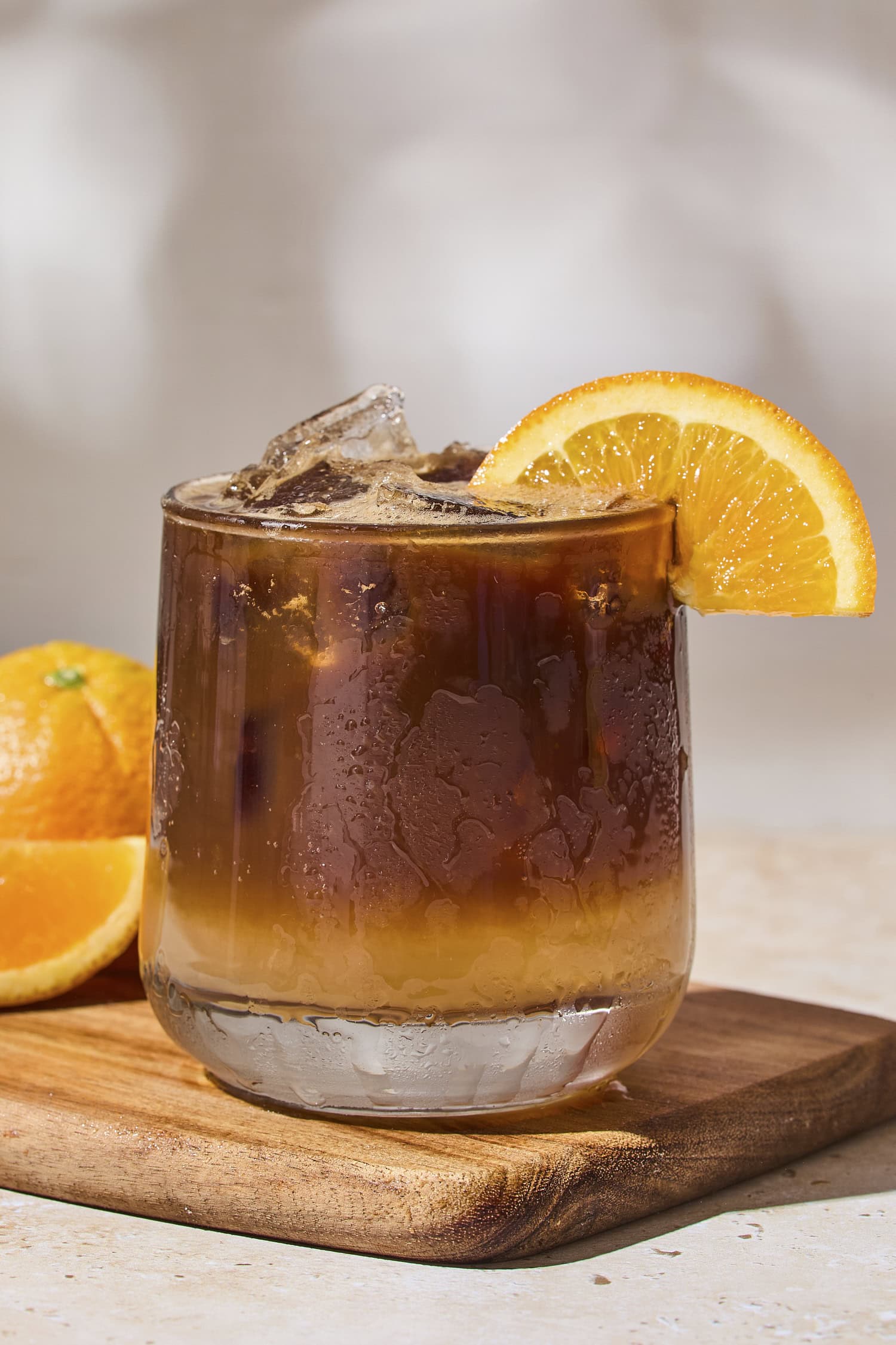 Espresso tonic with an orange wheel on the glass.