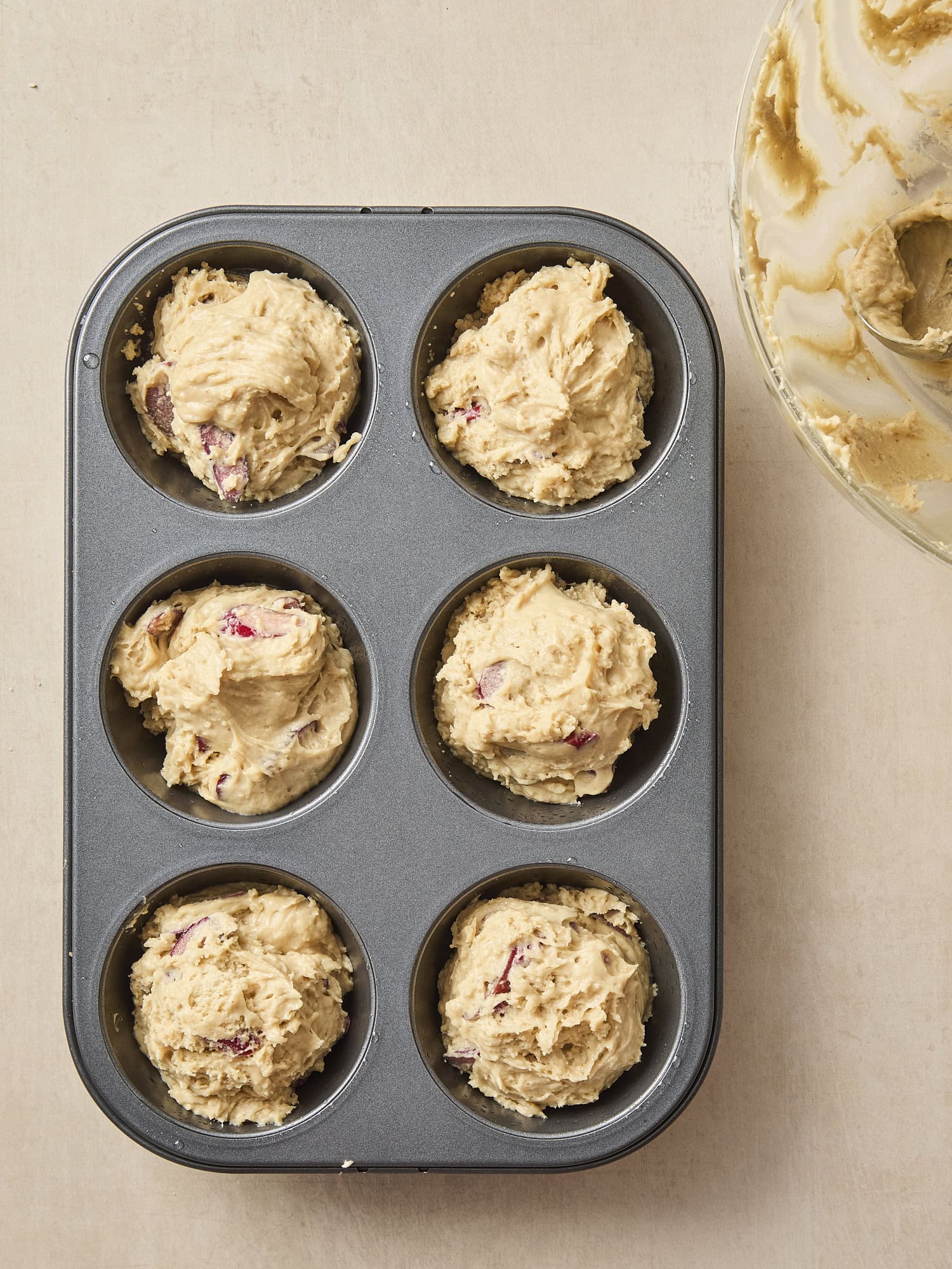 Muffin pan with batter in the tins.