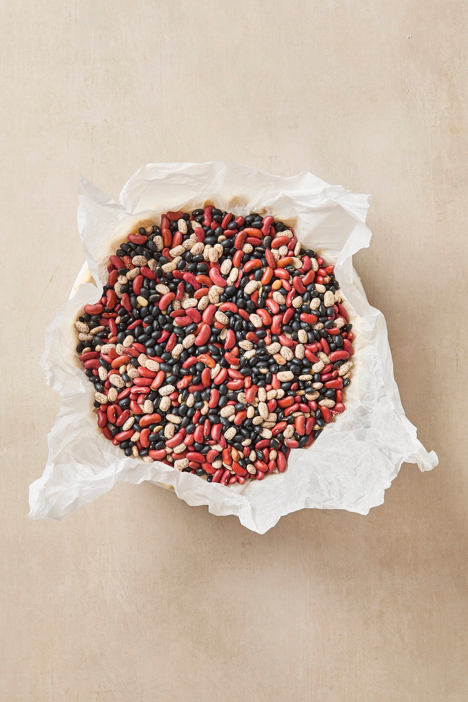 Pie shell filled with dried beans and parchment paper.