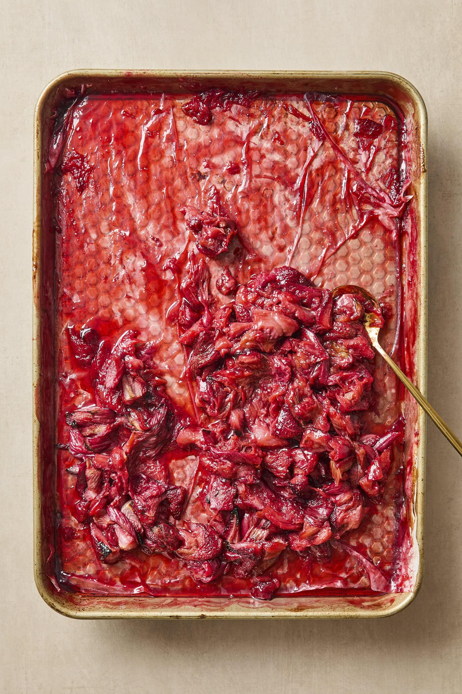 Sheet pan with roasted strawberries and rhubarb with juices.