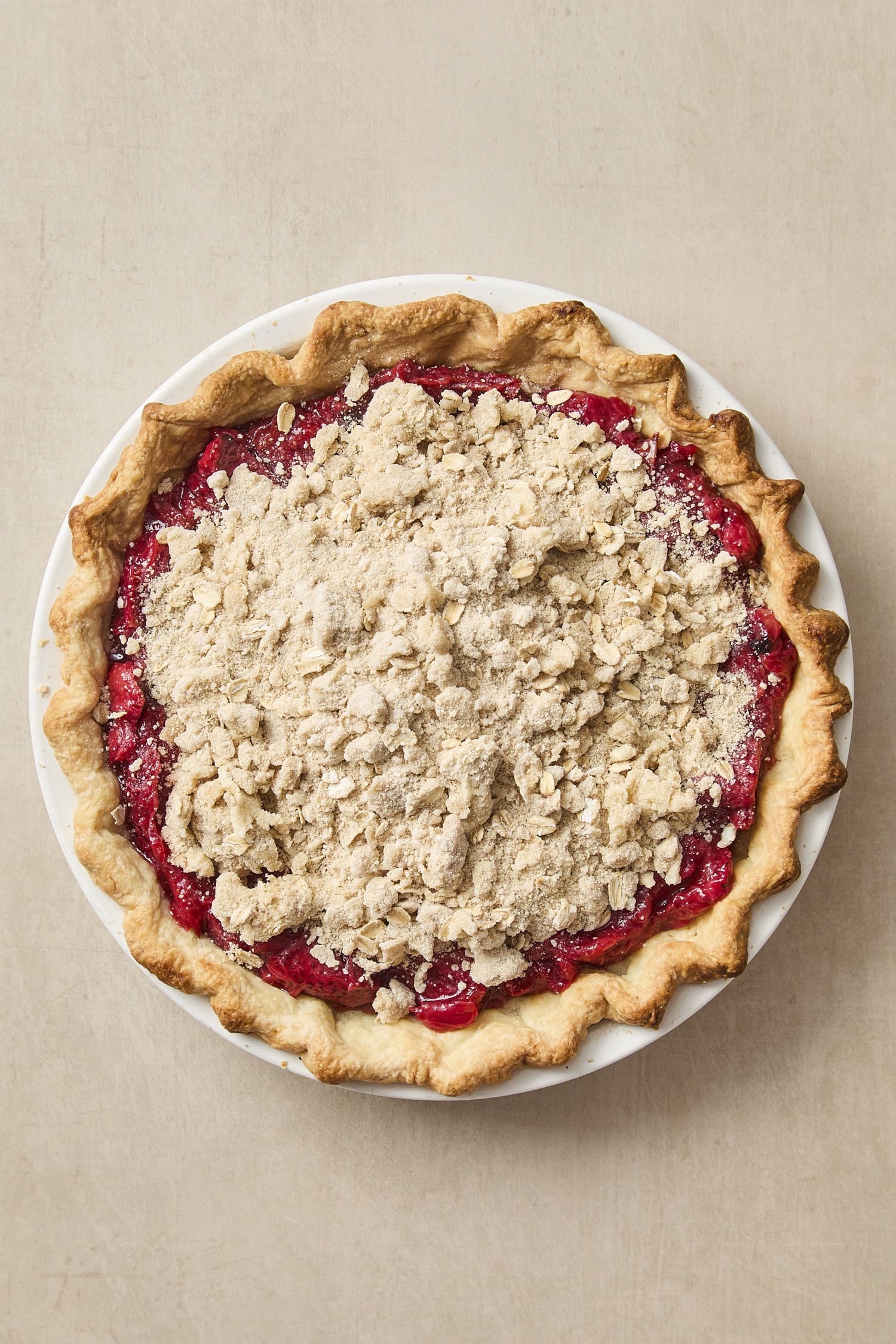 Strawberry rhubarb pie with unbaked crumble topping before going into the oven.