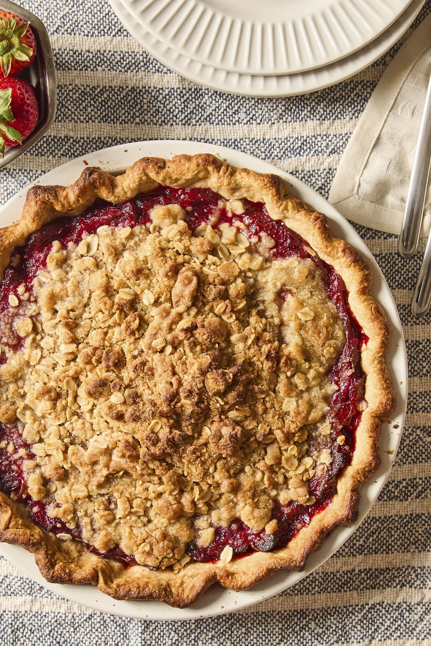 Baked pie with crumble topping before being sliced.