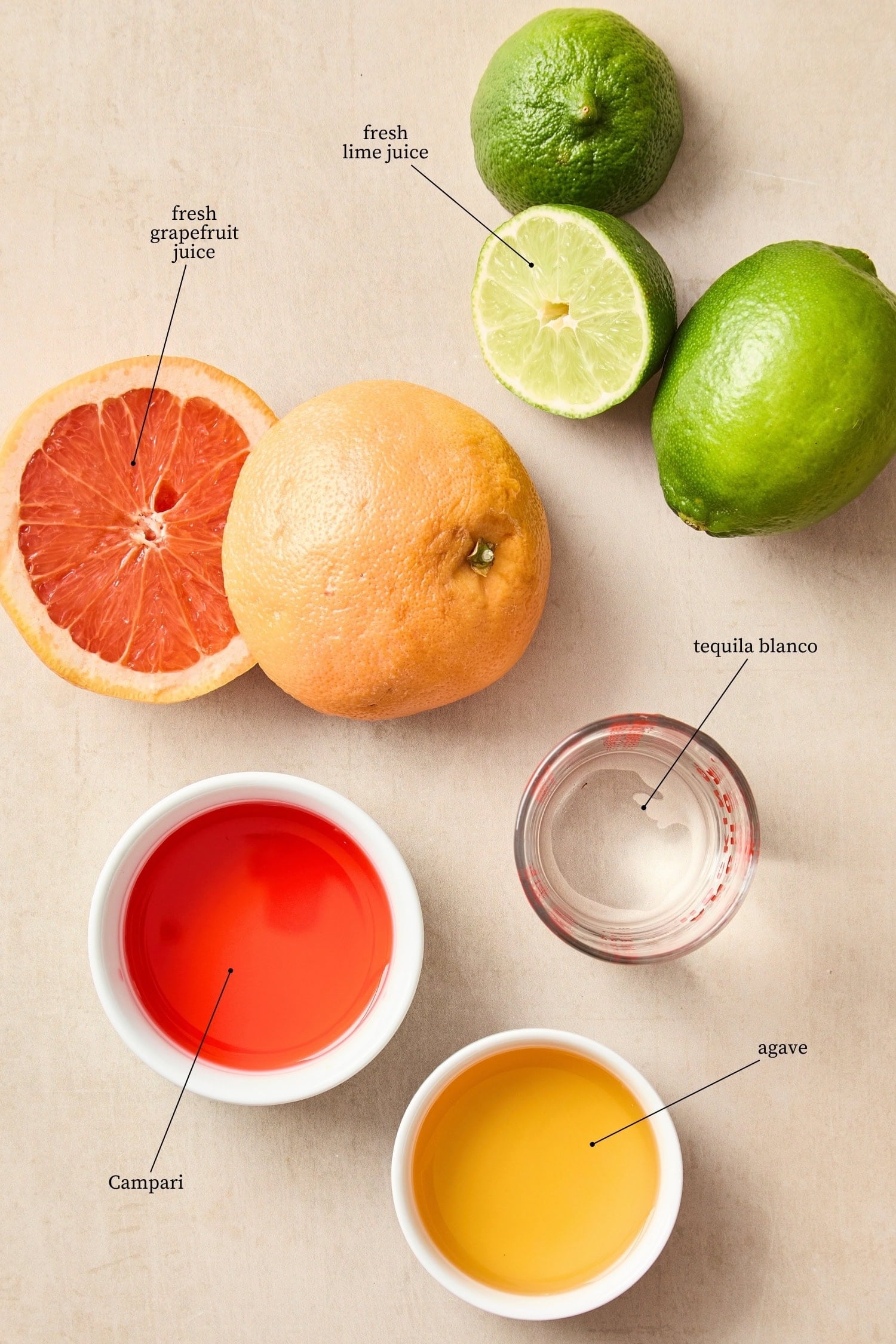Ingredients needed to make siesta cocktail including Campari, tequila, citrus, and more.
