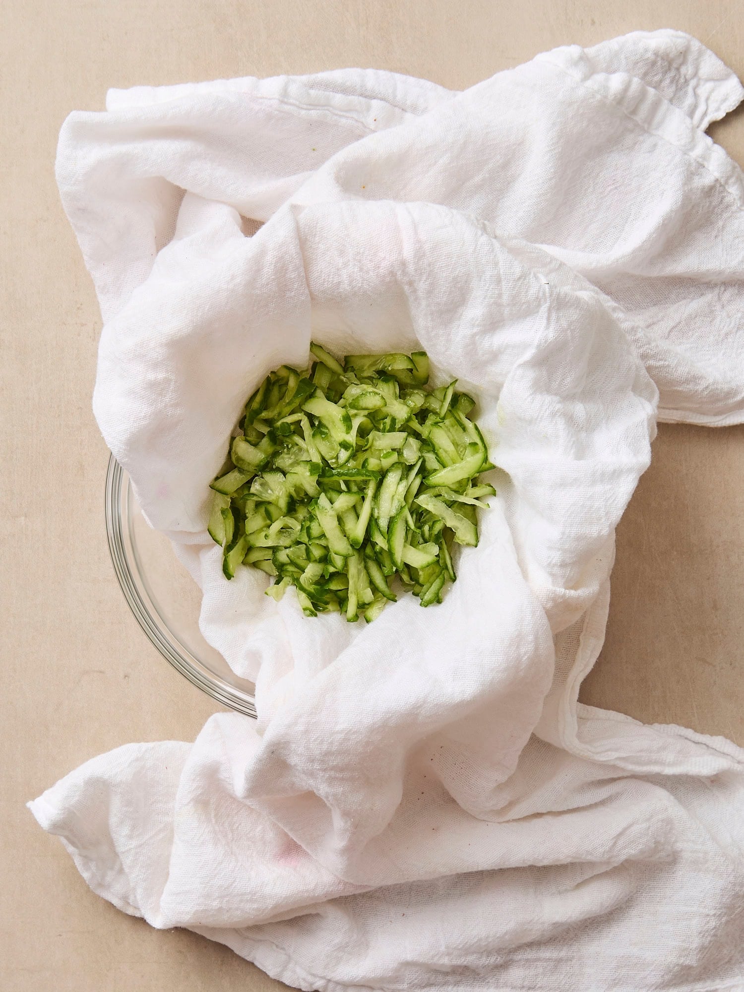 Towel with grated zucchini after being squeezed out.