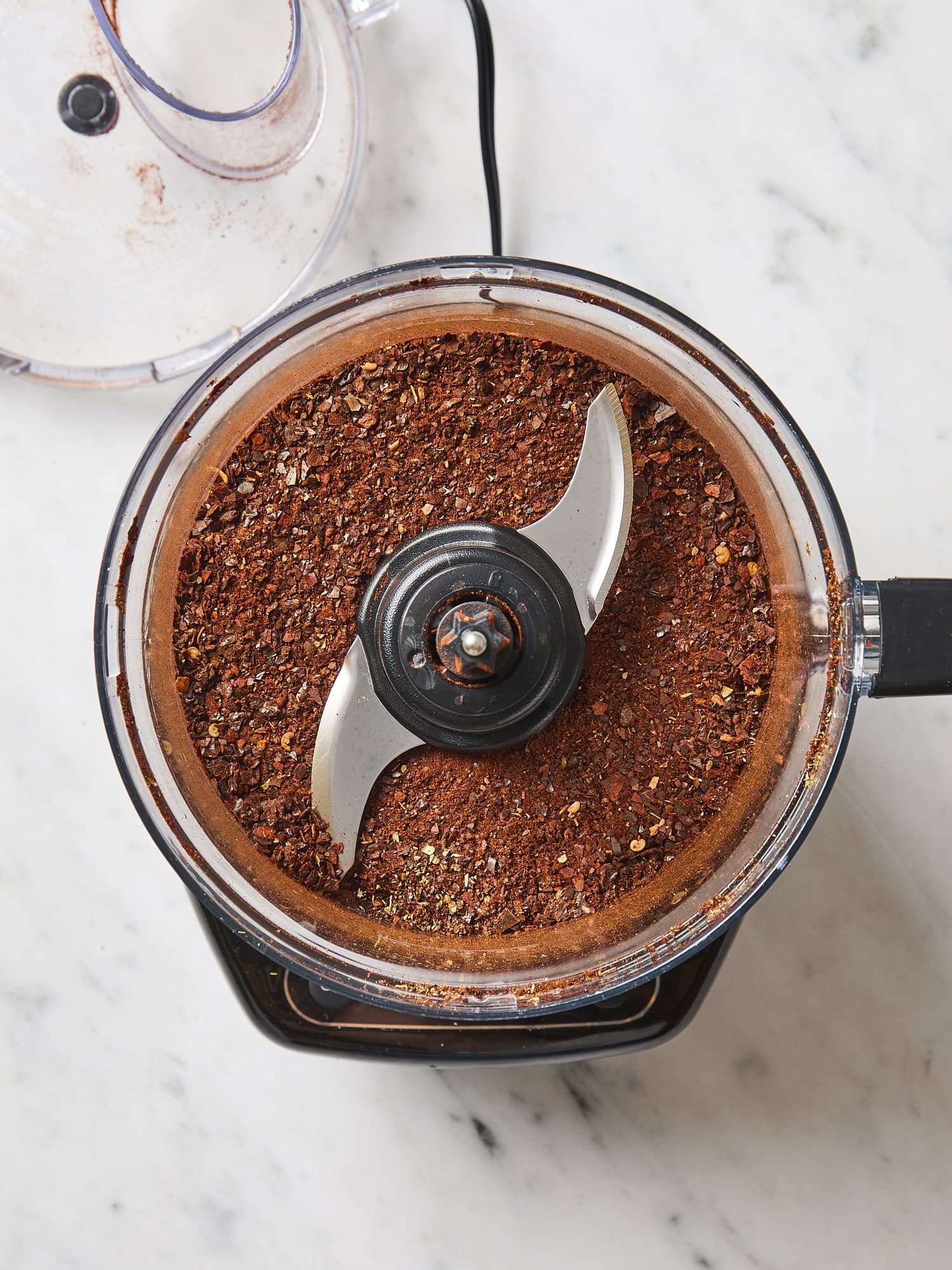 Homemade chili powder in a food processor after being ground up.