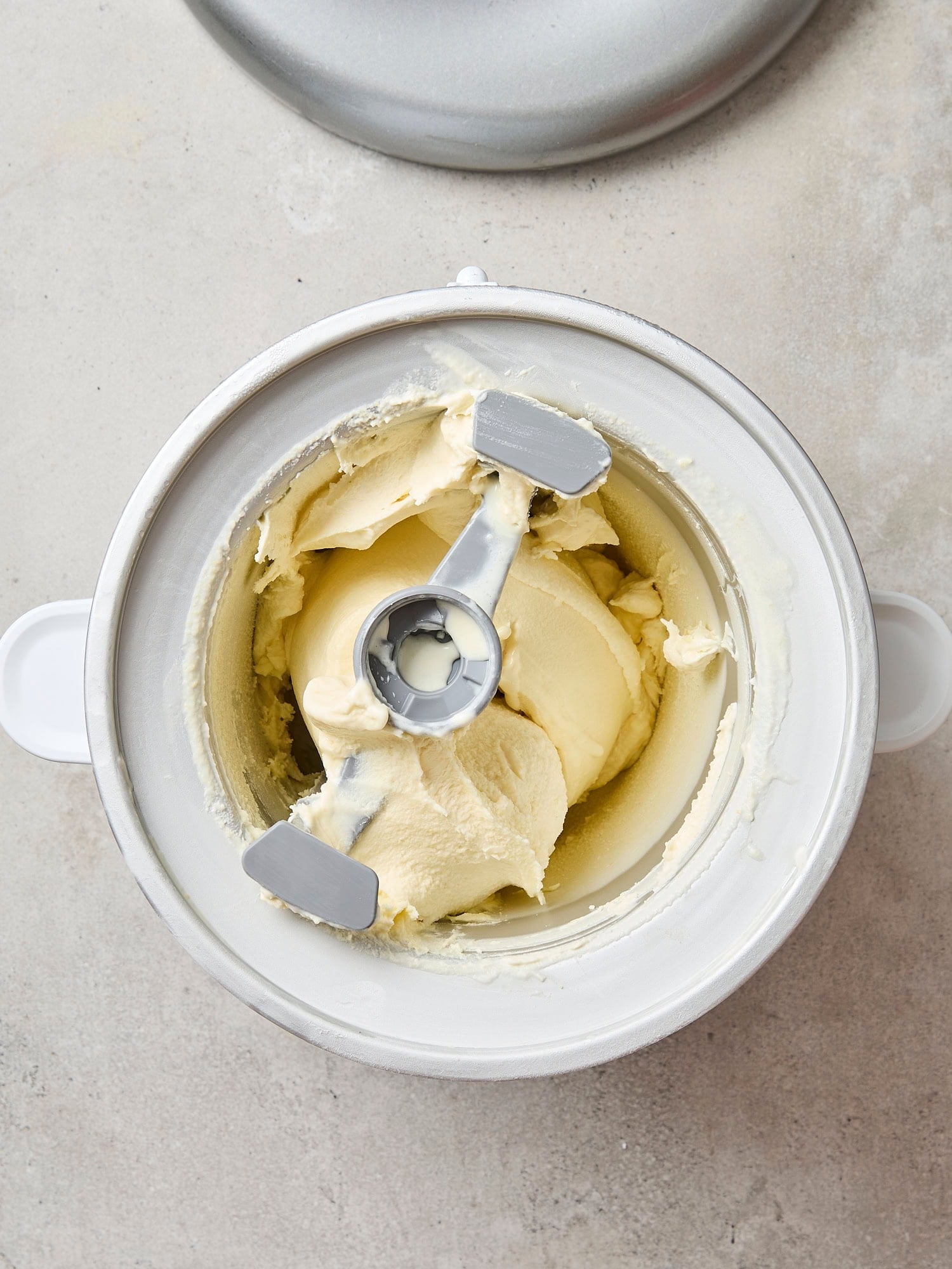 Container filled with churned soft sweet corn ice cream.