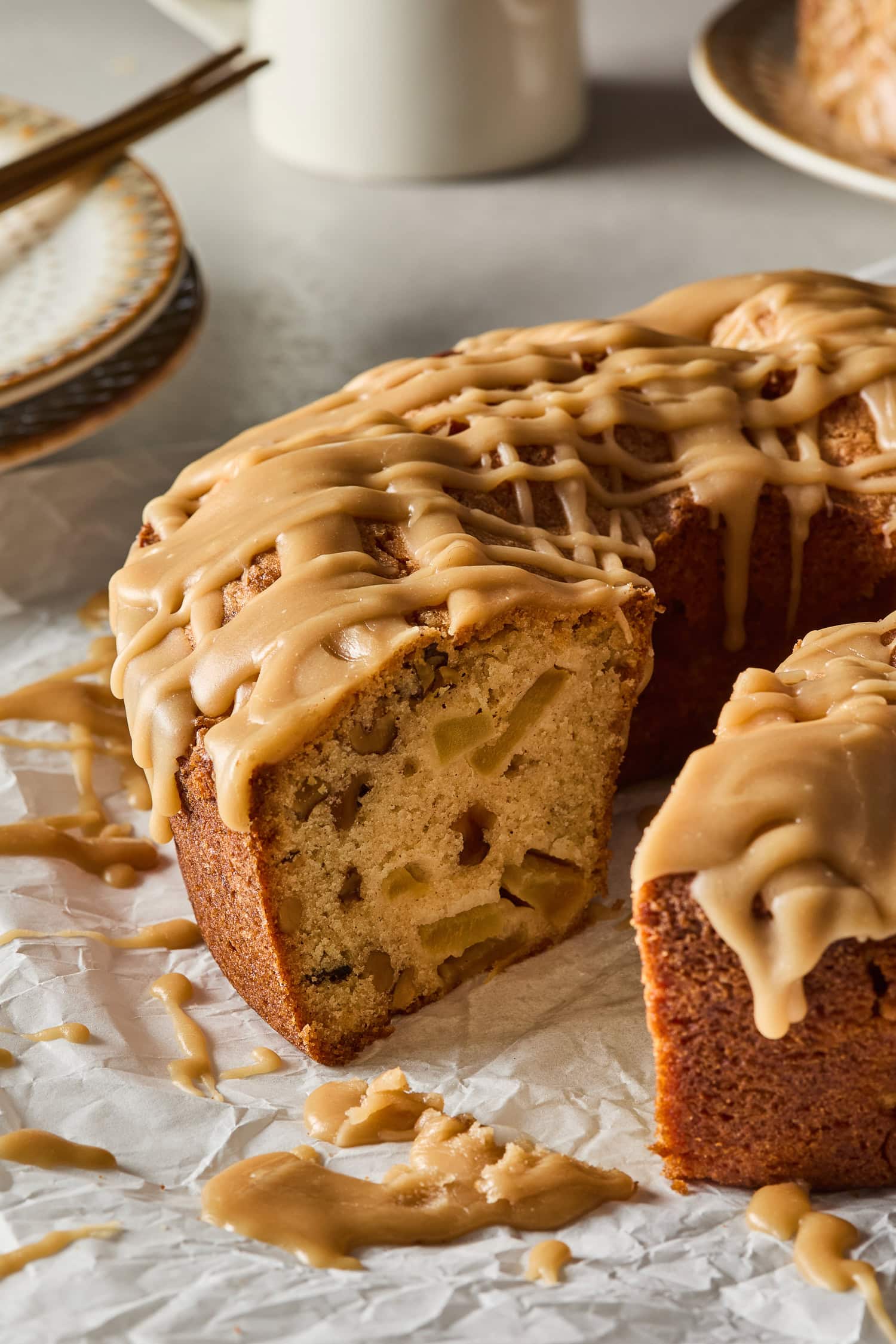Crosscut section of spiced apple cake revealing chunks of apple.
