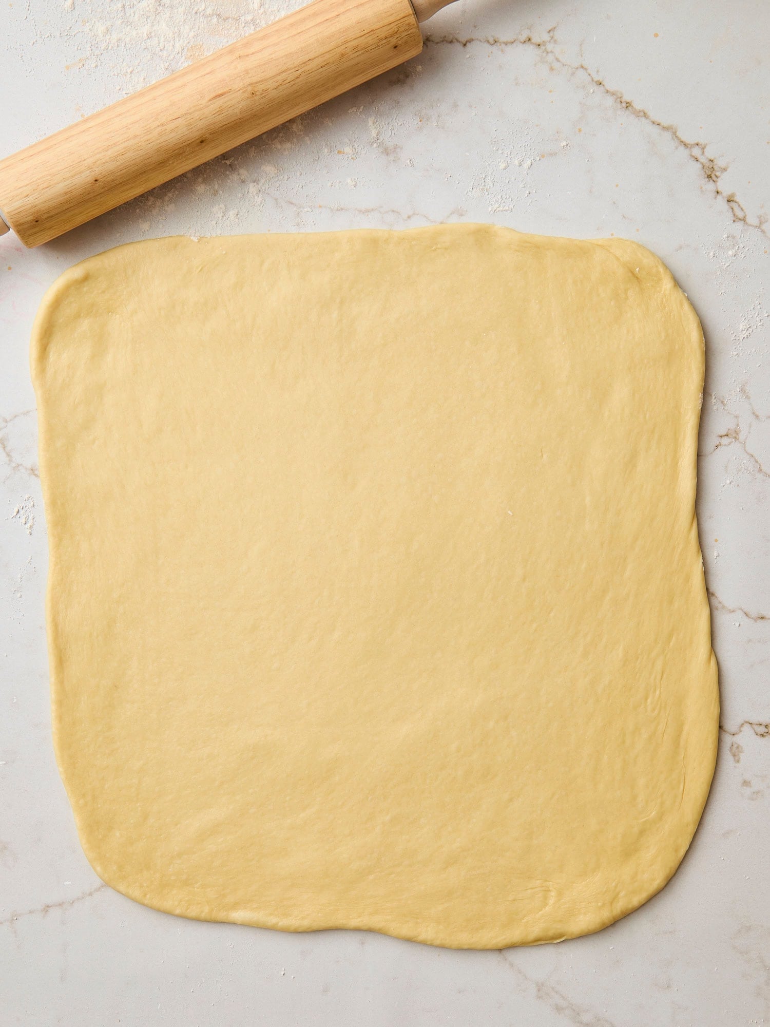 Rolled out brioche dough in a rectangle.